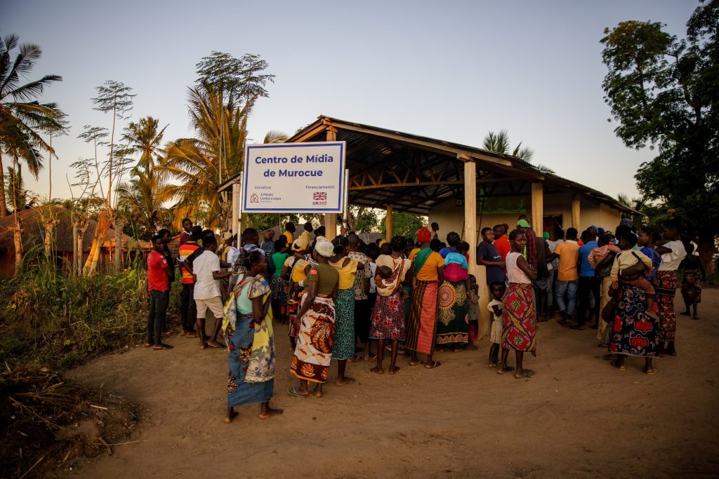 A group of people stood around a community hub in Mozambique 