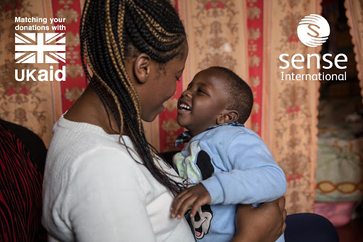 A Sense International campaign image for the 'Chance to Shine' campaign featuring a smiling mother and child