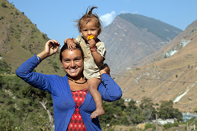 A woman with a child on her shoulder. Photo credit: Phase Worldwide