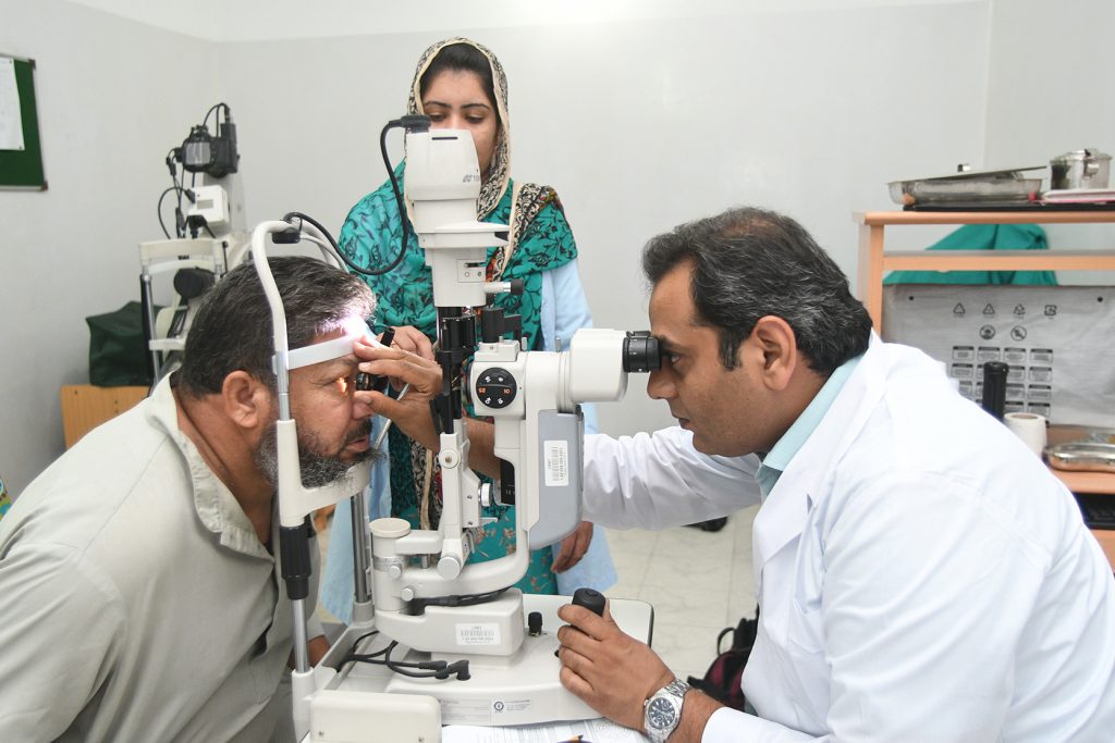 A cataract patient, is examined by Dr Khawaja Naeem Akhtar at LRBT Mandra, Pakistan. Credit: Jamshyd Masood/Sightsavers 2018