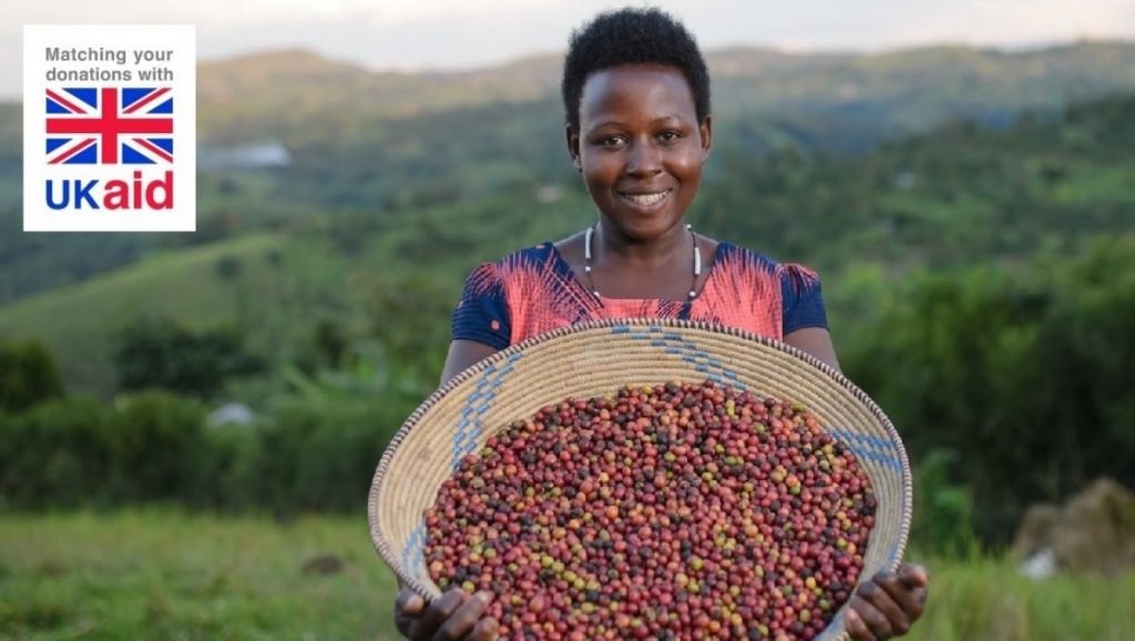 Ugandan farmer displays her coffee beans. Photo credit: Farm Africa/Jjumba Martin
