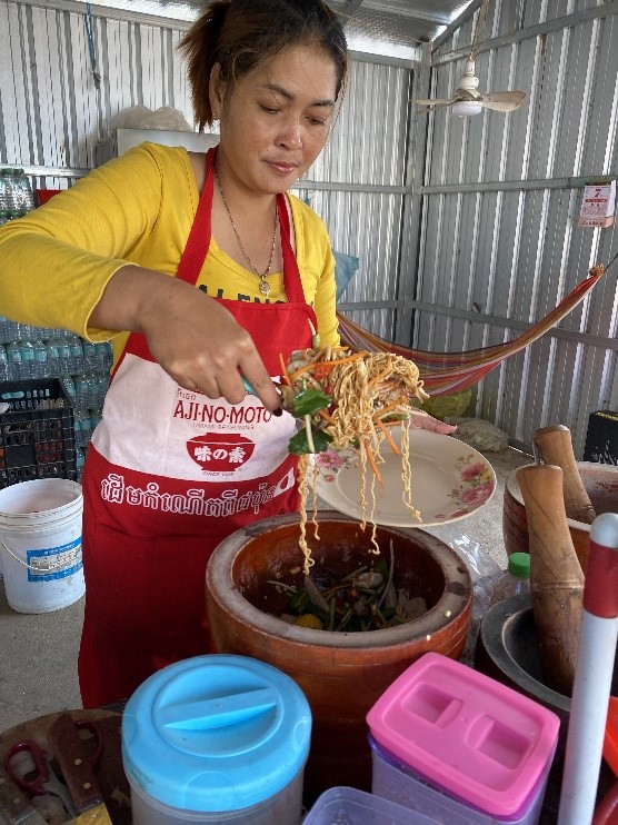 A woman stood in her kitchen cooking stir fry